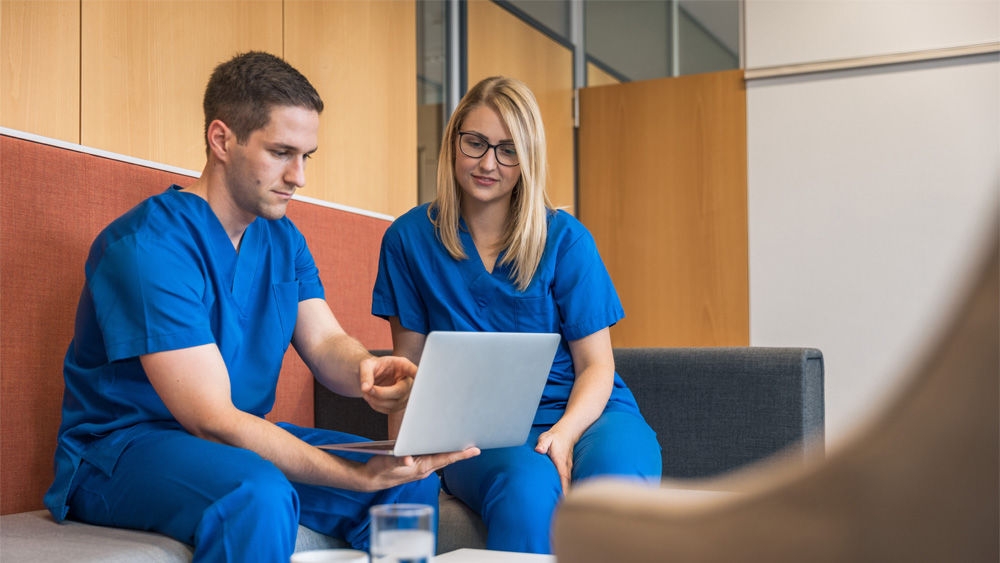 Two healthcare professionals attending to a digital session about Diabetic Foot Ulcer infections
