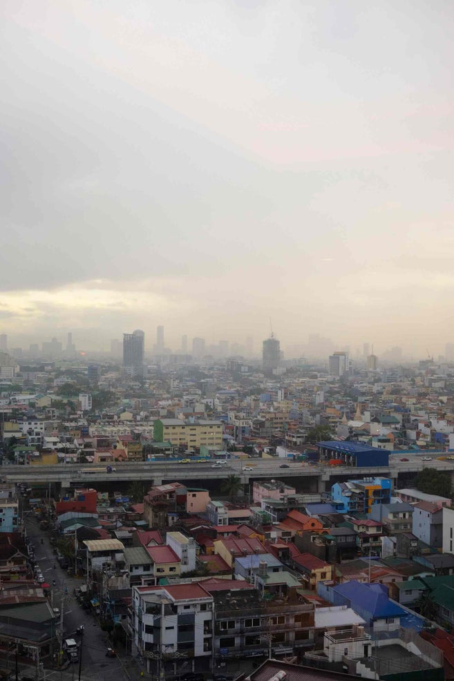 Aerial view of a densely populated urban area with hazy skyline