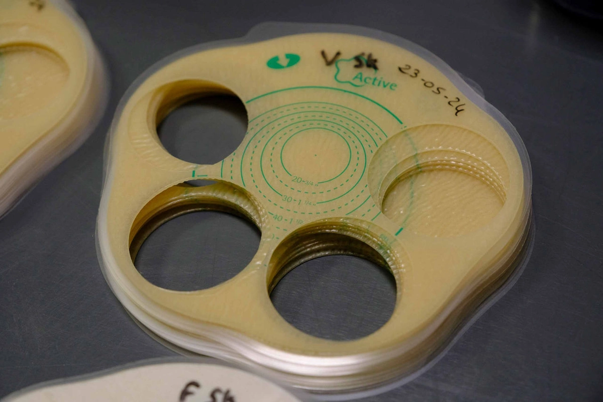 Close-up of circular beige items with cutouts and green "Active" labels