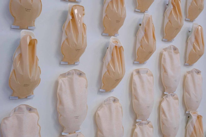 Several ostomy bags arranged on a wall