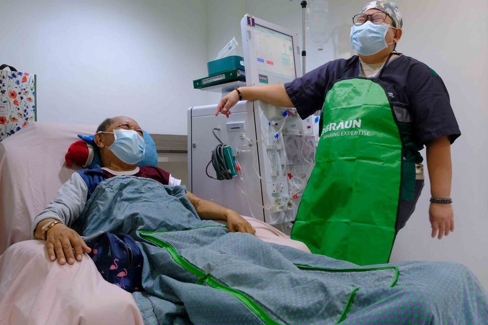 A man sorts stoma bags on a table